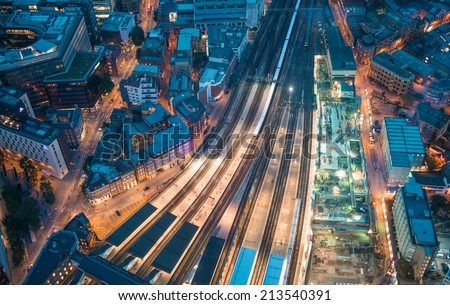 London. Train station and Tower Bridge night lights, aerial view.