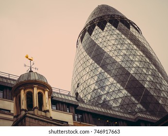LONDON, U K - March 19, 2017: Londonon a cloudy day in March.The skyscraper of 30 St Mary Ax or Gherkin in the background on the old buildings of London's financial district. 