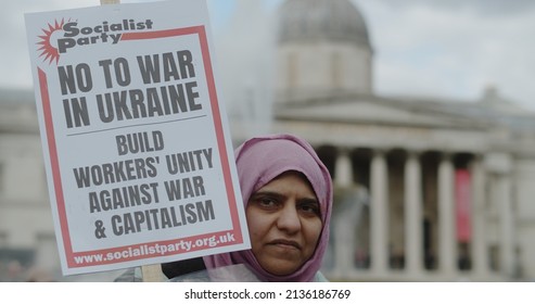 London, UK - 03 06 2022: A Woman Protester On Trafalgar Square Holding A Sign, ‘No To War In Ukraine. Build Workers’ Unity Against War And Capitalism’, In Support For Ukrainian People.