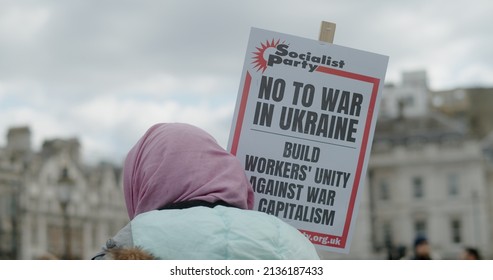 London, UK - 03 06 2022: A Woman Protester On Trafalgar Square Holding A Sign, ‘No To War In Ukraine. Build Workers’ Unity Against War And Capitalism’, In Support For Ukrainian People.