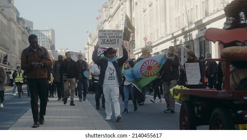 London, UK - 03 19 2022: Man Walking On Regent Street Holding Sign At Protest, ‘Now I’m Proud! I’ve Got My White Superior Jeans!’, At The Yearly ‘March Against Racism’, ‘UN Anti Racism Day’.