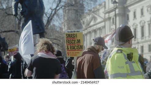 London, UK - 03 19 2022: A Man Protester At Parliament Square Holding A Sign, ‘Smash Fascism And Racism’, For The Yearly ‘March Against Racism’, Held Around ‘UN Anti Racism Day’.