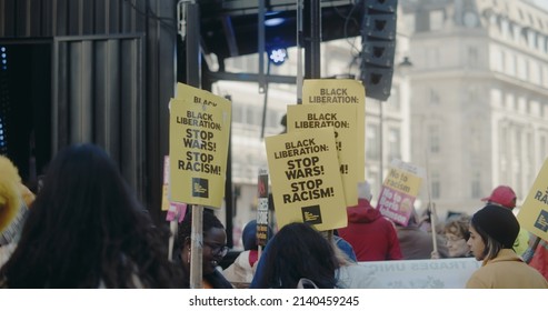 London, UK - 03 19 2022: A group of women at Portland Place holding signs, ‘Black Liberation: Stop Wars! Stop Racism!’, for the yearly ‘March Against Racism’, held around ‘UN Anti Racism Day’.