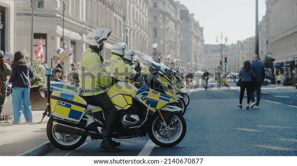London, UK - 03 19 2022: A line\
up of met police officers on motorbikes, on Regent street, for the\
yearly ‘March Against Racism’, held around the ‘UN Anti Racism\
Day’.