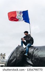 London / UK - 03/23/2019: Man Sitting On The Monument With French Flag At Brexit March