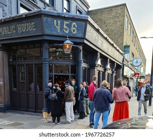 London. UK- 05.01.2021: A Group Of People Waiting To Enter  A Pub Garden To Enjoy A Social Evening After The Easing Of Covid-19 Lockdown.