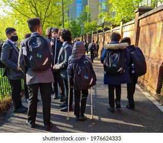 London. UK- 05.18.2021:  A Crowd Of Secondary School Pupils In Uniform On Their Way To Attend School On A Sunny Spring Morning.