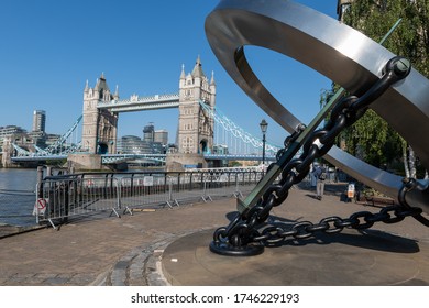 London. UK- 05.30.2020: The Timepiece Sundial Sculpture In St. Katherine Dock Marina With A View Of The Thames River And Tower Bridge In The Background On A Beautiful Sunny Blue Sky Spring Day.