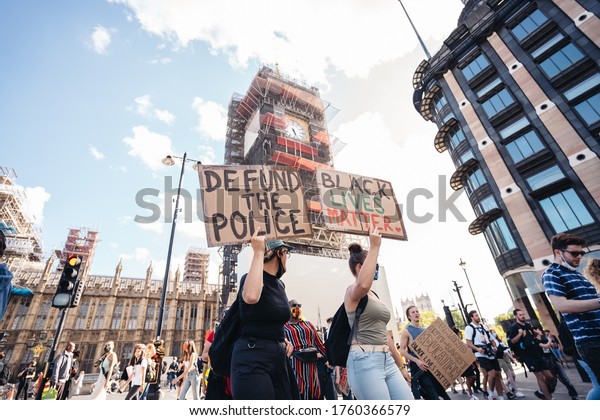London / UK - 06/20/2020: Huge crowd of Black\
Lives Matters protesters heading to Trafalgar square, chanting and\
holding defund the police\
banners