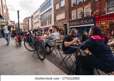 London / UK - 07/11/2020: People Sitting On The Busy Restaurant Terrace In Soho Area During Coronavirus Lockdown Ease