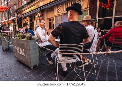 London / UK - 07/11/2020: People Sitting On The Busy Restaurant Terrace In Soho Area During Coronavirus Lockdown Ease