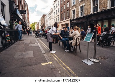 London / UK - 07/11/2020: People Sitting On The Busy Restaurant Terrace In Soho Area During Coronavirus Lockdown Ease