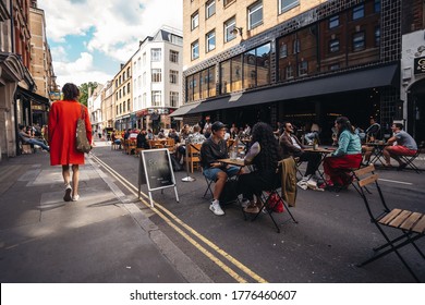 London / UK - 07/11/2020: People Sitting On The Busy Restaurant Terrace In Soho Area During Coronavirus Lockdown Ease