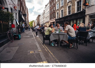 London / UK - 07/11/2020: People Sitting On The Busy Restaurant Terrace In Soho Area During Coronavirus Lockdown Ease