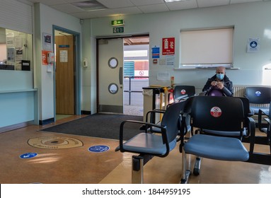 London. UK- 10.26.2020: the waiting room and reception of a hospital with strict appointment control system limiting the number of patients and visitors as part of Covid-19 safety measure.