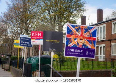 LONDON, UK - 11TH APRIL 2021: A row of Estate Agent Signs (T-boards) on a street in London.