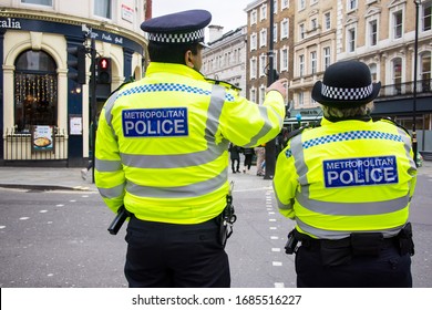 London, UK - 12 March, 2020 , Police Are Patrolling The City. View Of The Police From The Back.