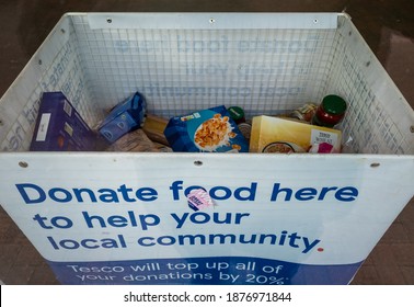 London. UK- 12.16.2020: a container in Tesco supermarket for customers to donate food for the poor and people in poverty.
