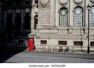 London\ UK - 13 Feb 2021: Empty London Street Scene With Red Telephone Box And Longs Shadows In Winter Sun In Front Of Old 19th Century Building