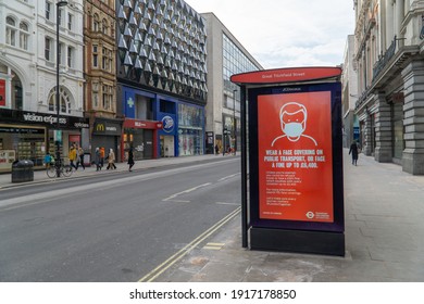 London, UK - 13 February 2021: COVID19 Public Transport Warning Sign - Wear A Face Mask Or Be Fined; Oxford Street, London