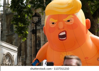 London, UK. 13th July 2018. EDITORIAL - The orange Baby Trump blimp being paraded around Parliament Square, London, UK, at the #BringTheNoise Women's March Anti Donald Trump protest demonstration.  
