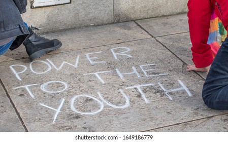 London, UK. 14th Feb 2020. Student Activists Chalking Slogans At The Youth Strike 4 Climate Demonstration Rally At Parliament Square, In Protest Of The Government's Lack Of Action On Climate Change.