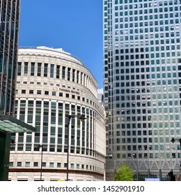 London, UK - 16 July 2019: Thomson Reuters building dwarfed by One Canada Square. Canary Wharf.