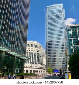 London, UK - 16 July 2019: Skyscrapers dwarf the Thomson Reuters building at Canary Wharf.