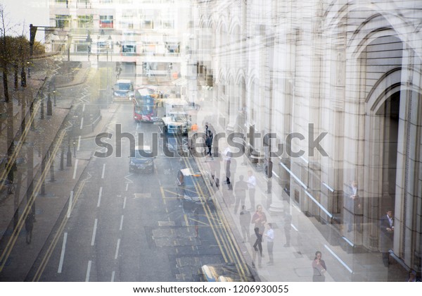 London, UK - 16 November,\
2016: Canary Wharf, Bank street view from the overpass tunnel.\
Public transport, buses, taxis and cars on the road. Busy modern\
life concept