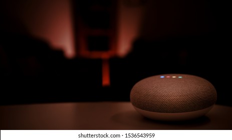 London, UK - 16th October 2019 - Google Home Mini Smart Speaker on a table in the living room