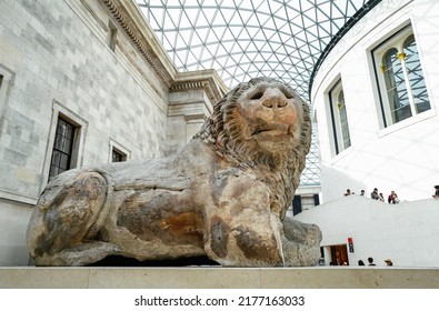 London, UK - 18th April 2022: The Lion of Knidos, a colossal Hellenistic marble statue of a recumbent lion dating from 2nd century BC, displayed in the Great Court of the British Museum. 