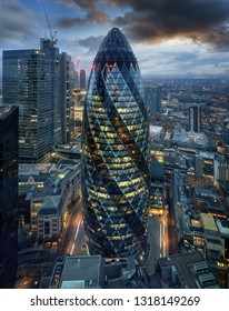 London, UK - 18th of February 2019: View to the City of London at evening time featuring the famous Gherkin Building by Sir Norman Foster, home of Swiss Re