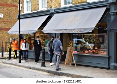 London, UK, 19th February 2021: People Queuing Outside A Local Meat Butchers In Central London During Covid-19 Lockdown.