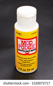 LONDON / UK - 2 OCTOBER 2019: Mod Podge Container Matte Glue Isolated On Black Background