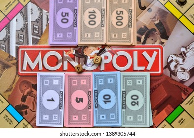 London, UK, 2020. Fake Currency Notes / Paper Money And Dice Neatly Arranged On Monopoly Board Game. Playing At Home In Quarantine During Lockdown 