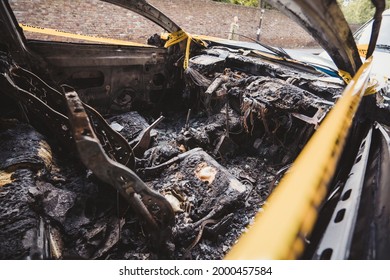 London | UK - 2021.06.12: Interior Of An Abandoned, Stolen Burnt Out Blue Car Parked On The Sideway Parking Spot б Tied With Yellow Do Not Cross Stripe