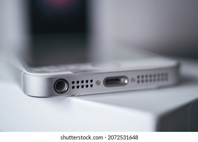 London | UK - 2021.10.09: Close Up Product Photos Of Headphone Jack Of Iphone SE In Silver Color Sealed In Plastic On Box