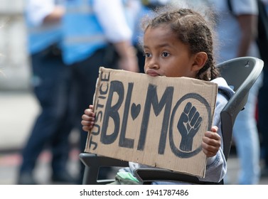 London, UK. 20th June 2020. Young child anti-racism campaigner with sign, at the Black Lives Matter rally in London, in protest of the death of Black American George Floyd by US police in Minneapolis. - Shutterstock ID 1941787486