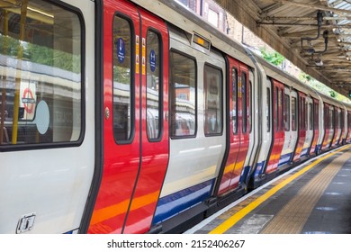 London, UK - 21 July, 2021 - A London Underground tube train waiting at Barons Court station, empty platform