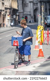 London, UK - 21 June, 2022: Delivery Man Cycling  In The City Of London. Street Photography