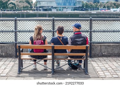 London, UK - 21 June, 2022: Family Enjoying The View On The Thames River Walk At Summer Sunny Day.  Street Photography