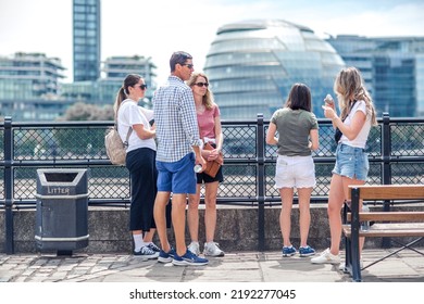 London, UK - 21 June, 2022: Family Enjoying The View On The Thames River Walk At Summer Sunny Day.  Street Photography