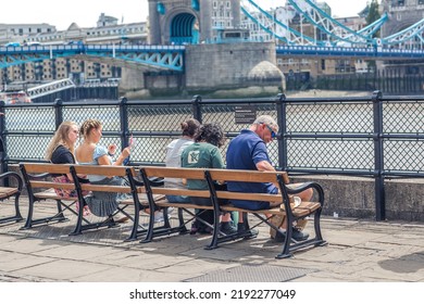 London, UK - 21 June, 2022: People Enjoying The View On The Thames River Walk At Summer Sunny Day.  Street Photography