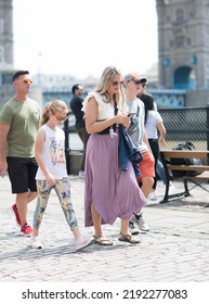 London, UK - 21 June, 2022: Family  Waking On The Thames River Walk At Summer Sunny Day.  Street Photography