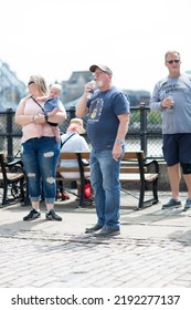 London, UK - 21 June, 2022: Family  Waking On The Thames River Walk At Summer Sunny Day.  Street Photography