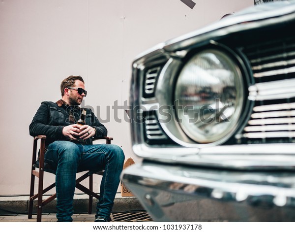 London / UK - 22.04.2017 : Guy Sitting Next To His\
Car at Classic Car Boot\
Sale