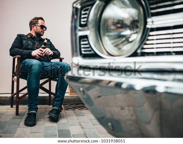 London / UK - 22.04.2017 : Guy Sitting Next To His\
Car At Classic Car Boot\
Sale