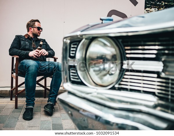 London / UK - 22.04.2017 :Guy Sitting Next To His\
Car At Classic Car Boot\
Sale