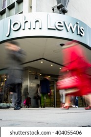 LONDON, UK - 23 NOVEMBER 2011: Blurred shoppers walking past the shop front to the John Lewis department store on London's Oxford Street.