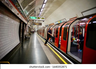 London, UK - 24 June 2019: Cityscape A Train Arrived Platform And Passenger Getting On Train.